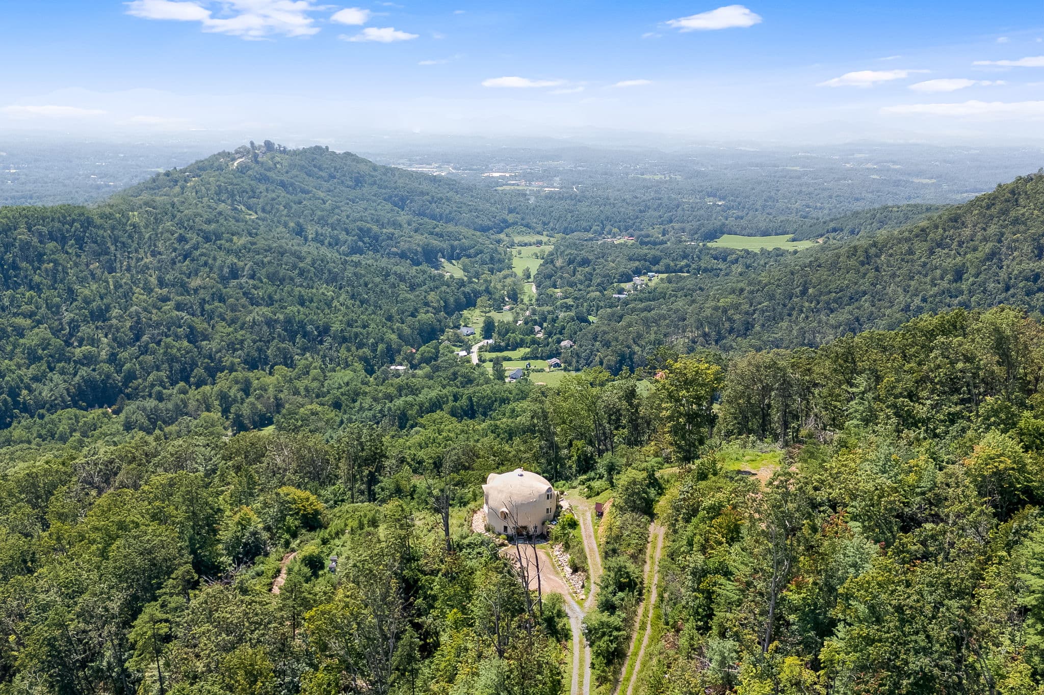 Aerial view of the dome home amid 29 acres of mountain forest