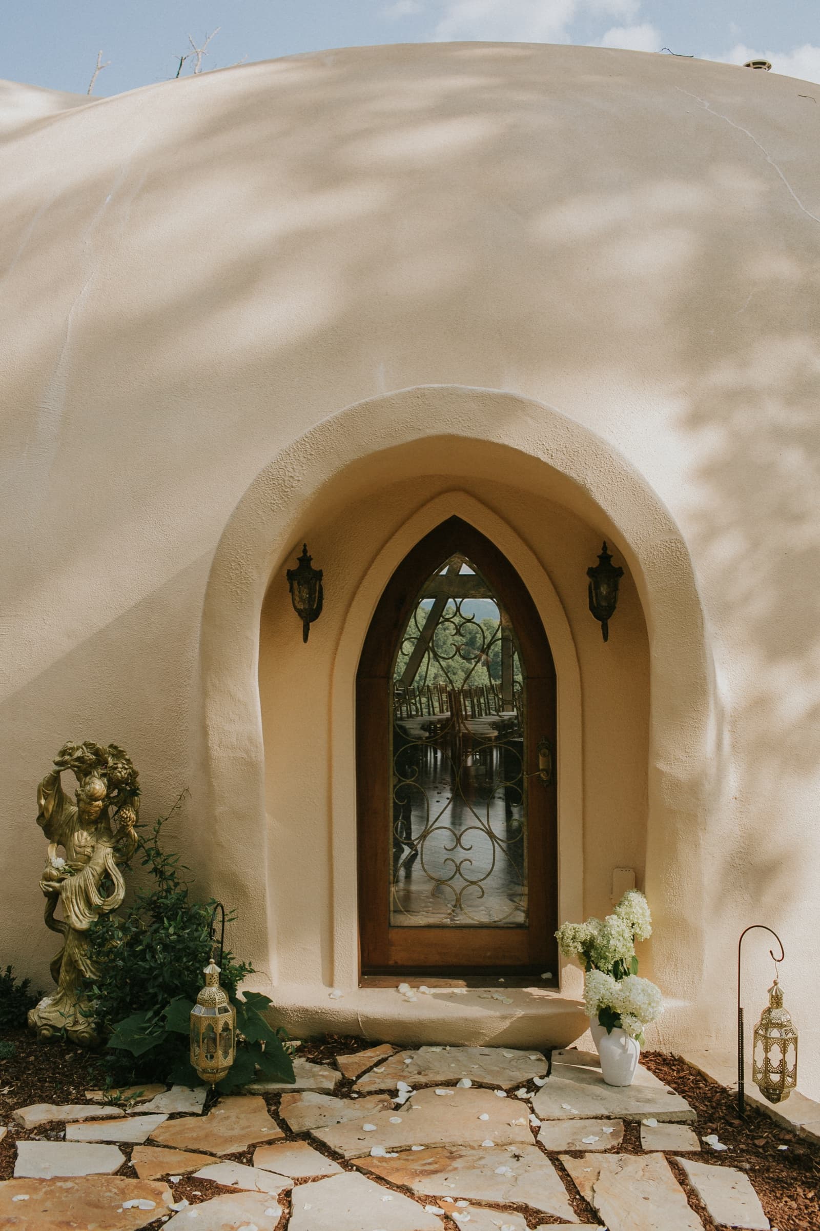Arched dome entrance framed with hydrangeas and Moroccan lanterns