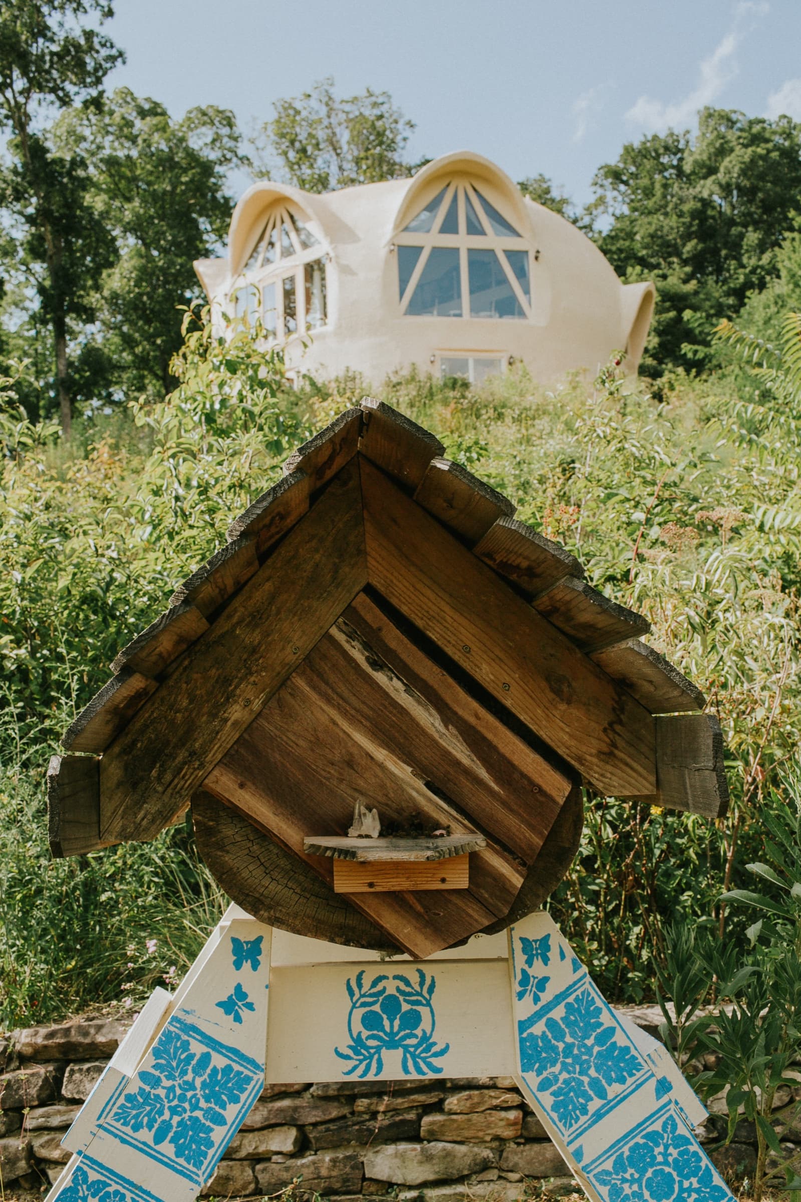 Painted beehive shrine in the wildflower meadow with the dome behind