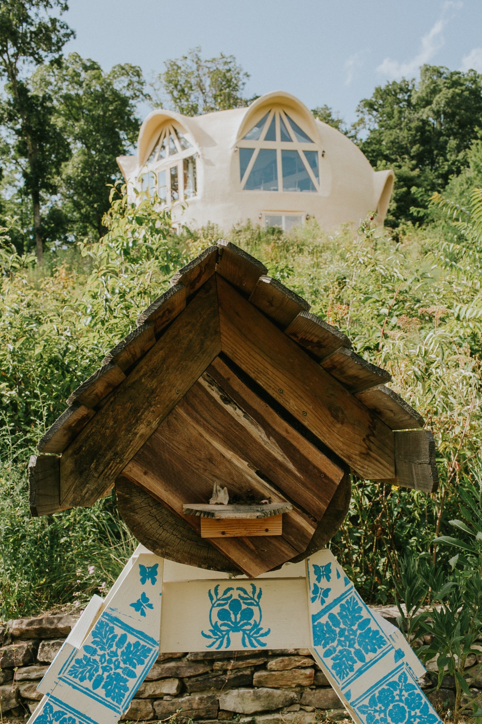 Painted beehive shrine in the wildflower meadow with the dome behind