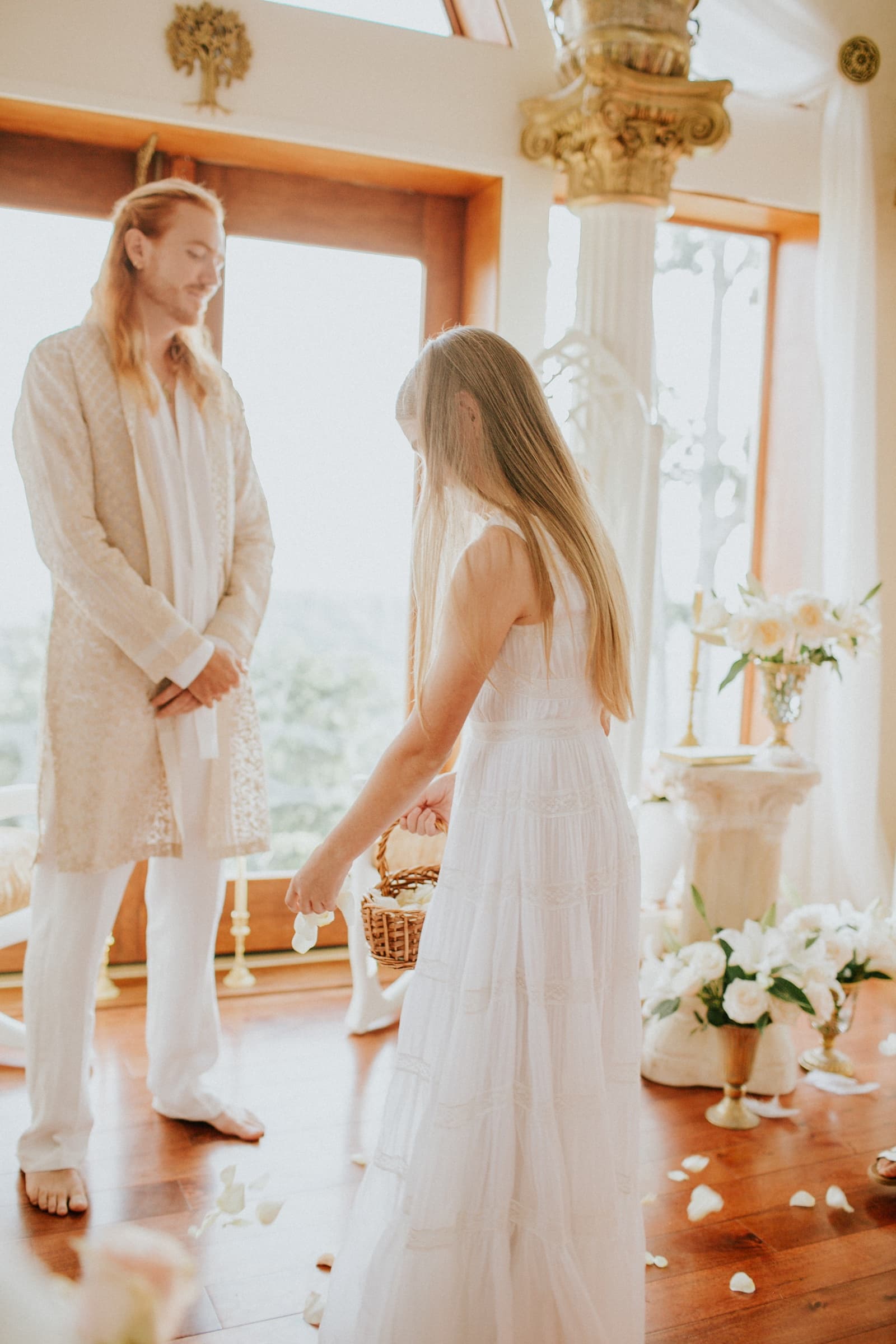 A flower girl scattering rose petals during a wedding ceremony at Azura