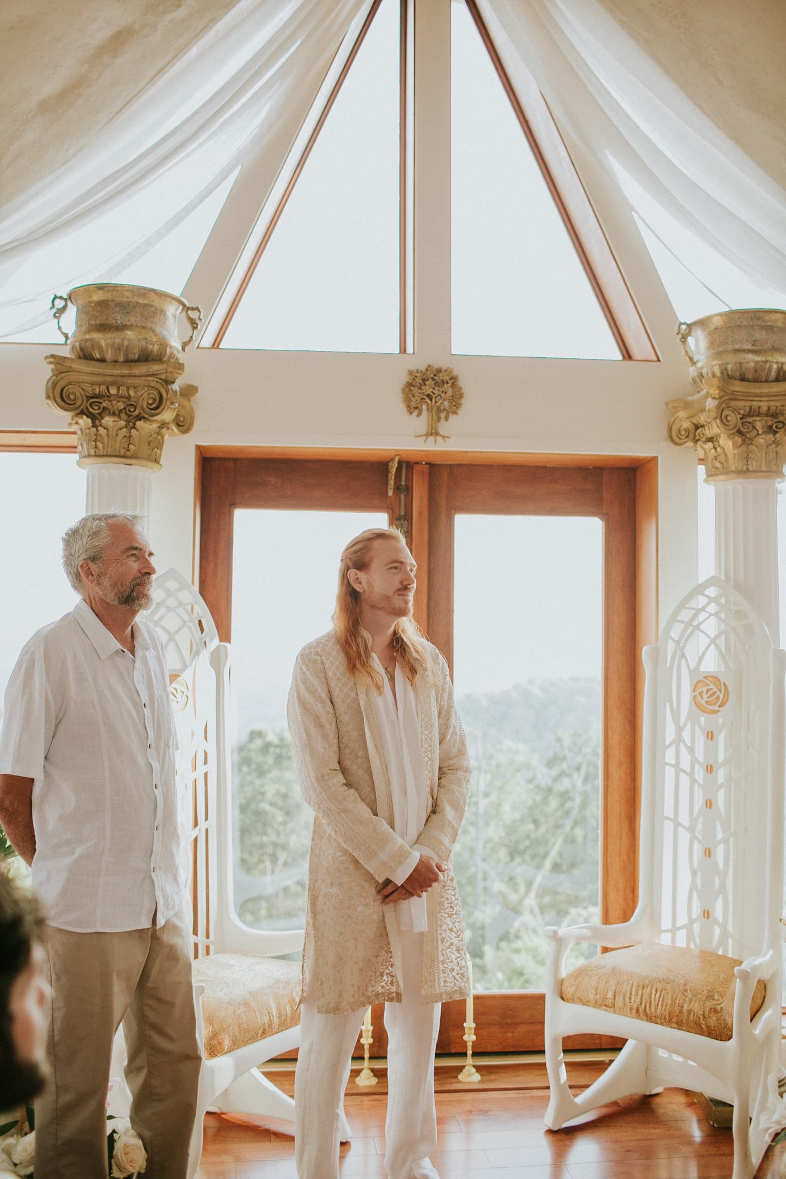 The groom waiting at the altar beneath the dome's cathedral windows