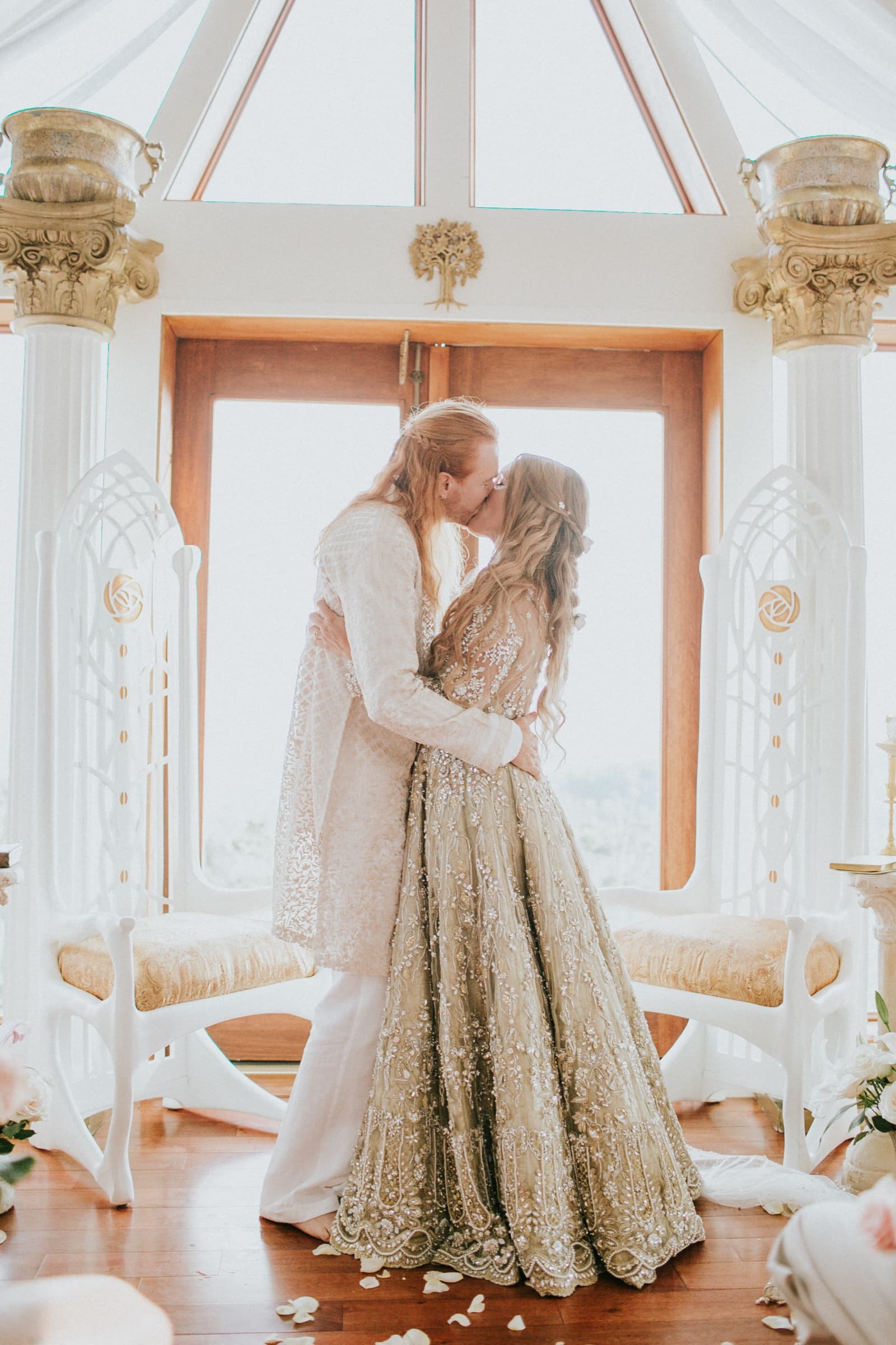 A newly married couple's first kiss beneath the dome's cathedral windows