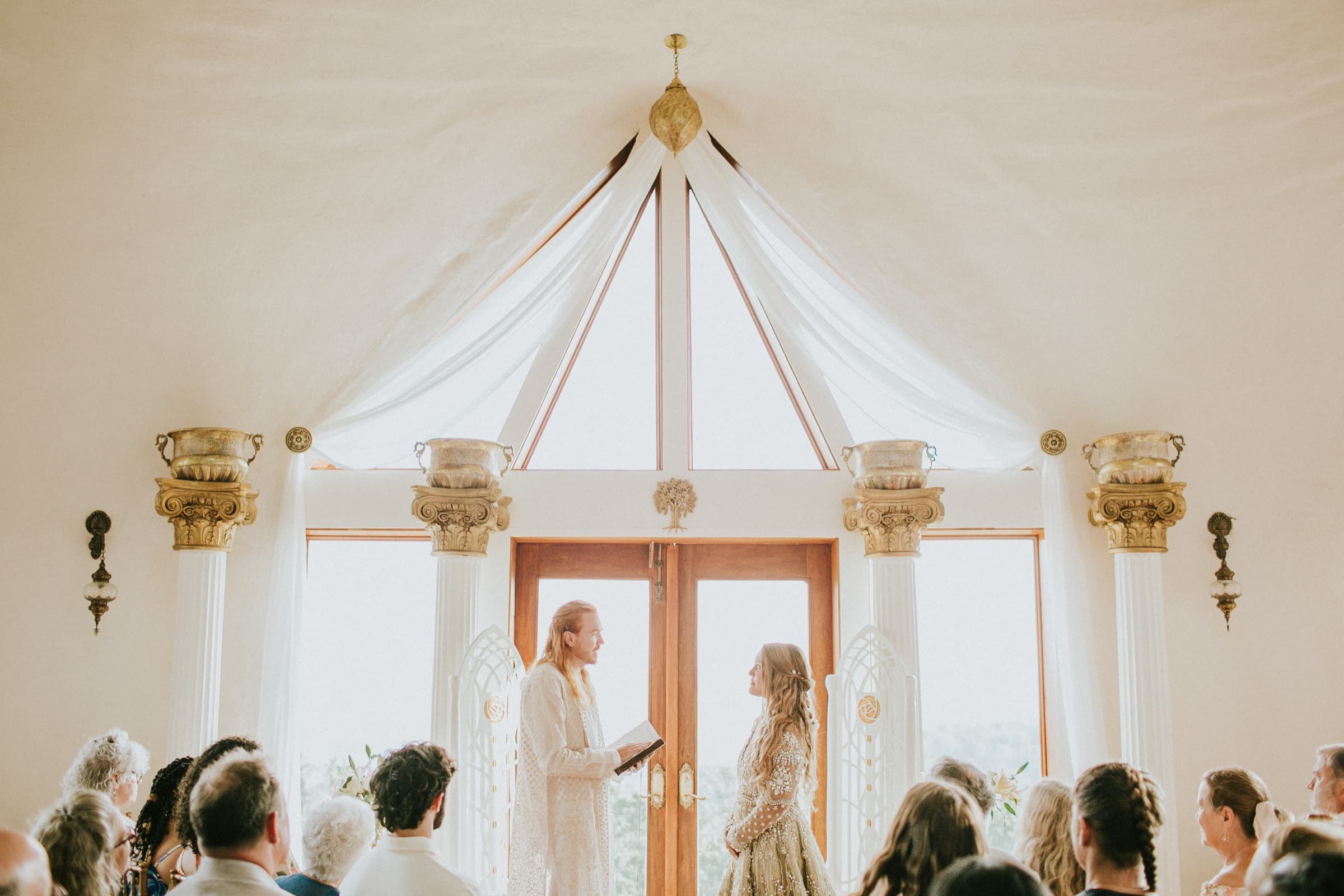 Wedding ceremony beneath the dome's cathedral windows at Azura